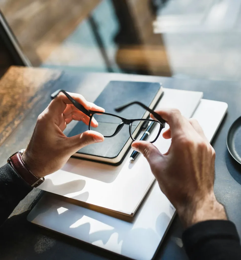 Ein Man hält eine Brille in der Hand